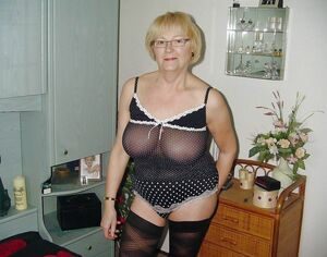 Sexpot mature ladies posing at home in stockings and fishnet lingerie.